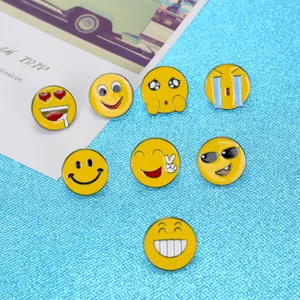 Collection de broches en émail emoji avec huit motifs de visages jaunes sur fond bleu vif
