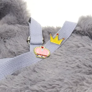Macro de deux pins en émail en forme de couronne jaune et rose sur tissu tressé