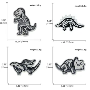 Detailed view of four dinosaur skeleton enamel pins with precise dimensions and weight