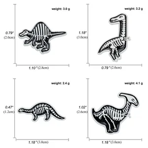Detail view of black and white enamel dinosaur skeleton pins with size measurements