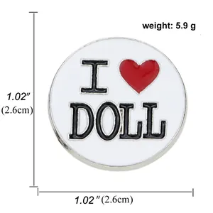 Detail of round enamel pin showing 2.6cm diameter and 5.9g weight with I Love Doll text