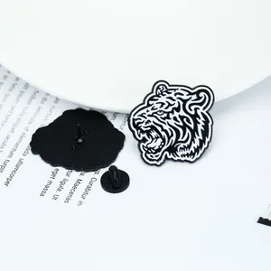 Detailed close-up of a black and white enamel tiger brooch with rubber pin back closure