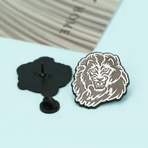 Detail of lion head enamel brooch showing front design and back pin with black rubber cap