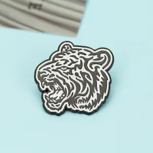 Macro view of geometric tiger head enamel brooch with black and white artistic lines
