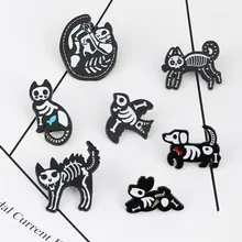 Détail de sept épingles en émail squelettes d'animaux dont chat et chien sur fond blanc