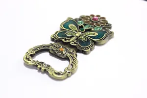 Close-up of vintage butterfly bottle opener with enamel coating and rhinestone details