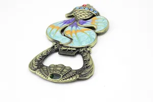 Macro detail of vintage goldfish beer opener with colorful enamel and rhinestones