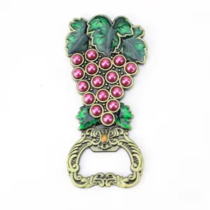 Vintage zinc alloy beer bottle opener featuring green enamel leaves and pink pearl grapes