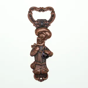 Détail d'un décapsuleur Afanti en bronze vintage avec relief d'art populaire gravé