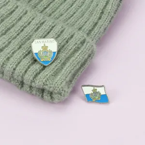 San Marino flag pins set with zinc alloy shield and waving flag emblems on a grey knit cap