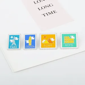 Set of four colorful enamel postage stamp pins featuring iconic world landmarks
