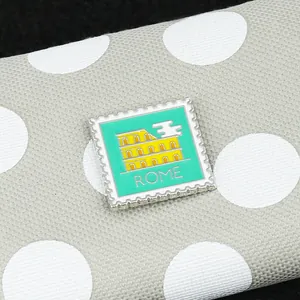Detailed macro view of the turquoise stamp-shaped Rome enamel brooch pin with serrated edges