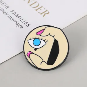 Detailed macro view of Picasso-style enamel eye brooch with vibrant blue and pink colors