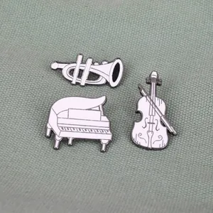 Cartoon white enamel musical instrument brooch set with piano, violin, and trumpet designs