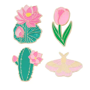 Set of 4 enamel pins featuring pink tulips, lotus, cactus and moth on white background