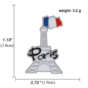 Close-up of Eiffel Tower enamel pin with French flag and Paris text detail