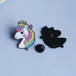 Macro detail of cartoon unicorn enamel pin with rainbow mane and rubber clutch backing