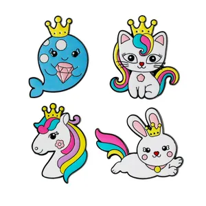 Set of four colorful enamel pins featuring rainbow animals like whales and unicorns