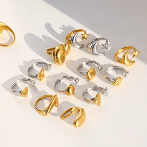 Collection of polished gold and silver croissant rings with shell and starfish motifs