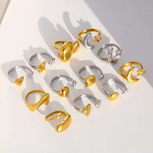 Flat lay of multiple gold and silver stainless steel rings with shell and star designs