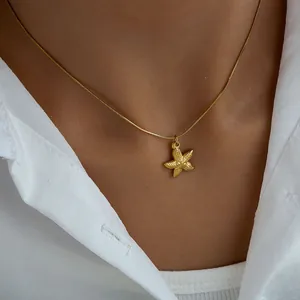 Detail of gold starfish pendant with textured finish on elegant snake chain necklace