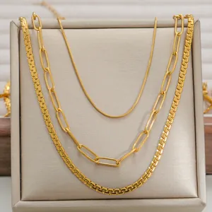 Three-layer layered gold necklaces featuring snake, paperclip, and box style chains