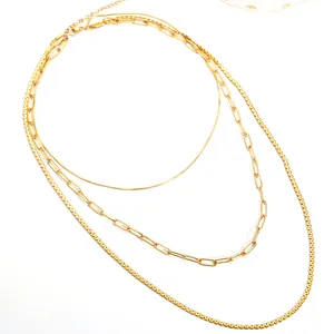 Detail of three-layer gold-plated layered necklace set with lobster clasp and extension chain