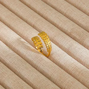 Detailed view of vintage gold enamel leaf ring with intricate textures on velvet lining