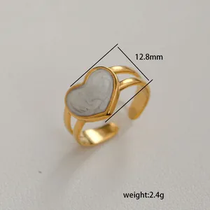 Detail of adjustable gold-finish ring featuring a 12.8mm marble pattern heart inlay