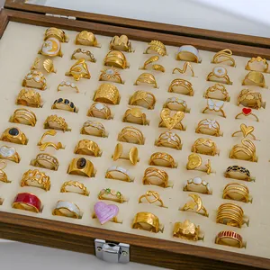 Vintage gold enamel pearl silver rings set displayed in a wooden velvet jewelry box