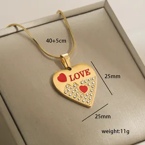 Detailed view of 14k gold heart necklace with LOVE engraving and crystal accents