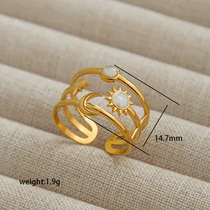Detail of celestial gold open ring featuring sun moon stars and white shell inlay