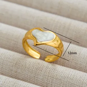 Detail of 12mm golden heart-shaped open ring with a glossy white enamel inlay finish