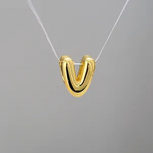 Detailed close-up of 3D gold balloon letter V pendant with a high-polished mirror finish