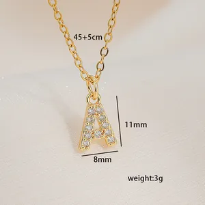 Macro detail of gold square letter A necklace with zircon inlay and product dimensions