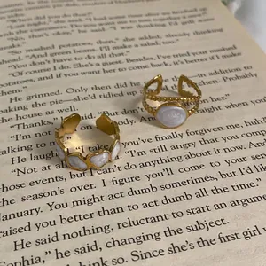 18K gold-plated oval enamel ring with heart pattern and beaded texture on vintage book