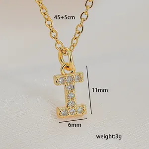 Close-up of gold letter I pendant with sparkling cubic zirconia on a silk background