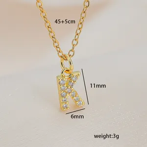 Detailed view of gold K letter necklace with dimensions 45+5cm length and zircon inlay