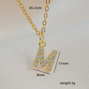Detail of gold letter M pendant with cubic zirconia and specific size dimensions