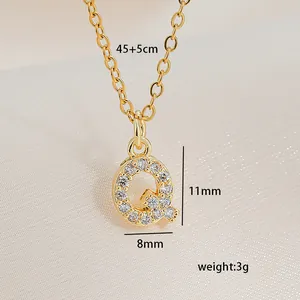 Detailed view of gold square letter Q pendant with zircon inlay and chain size specs