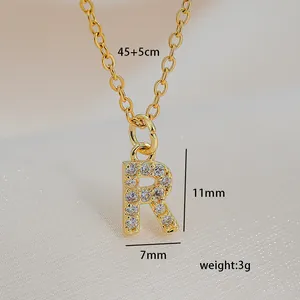 Macro shot showing dimensions of letter R pendant with cubic zirconia and gold chain
