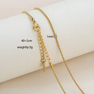 Detailed view of 1mm gold box chain with lobster clasp and 40+5cm extension on a stand