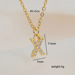 Detailed view of gold letter X pendant with cubic zirconia, size 11mm by 7mm
