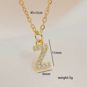 Macro view of gold initial Z pendant with white zircons and detailed dimensions