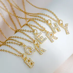 Gold square letter pendant necklace set with cubic zirconia on white display stand