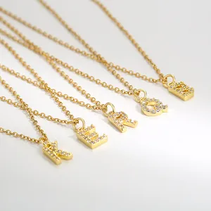 Gold plated square initial necklaces with micro-pave cubic zirconia on white background