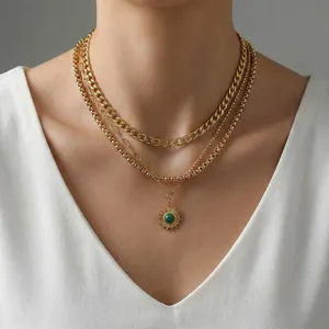 Three-layer gold-plated star necklace with green stone sun pendant on white V-neck