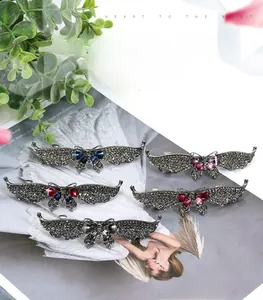 Macro detail of luxury butterfly hair clips with colorful rhinestones and resin gems