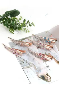 Detail of rose gold alloy butterfly hair clips with colorful resin rhinestones