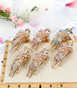 Set of six large rhinestone hair claws in various colors on a soft cream display tray